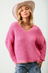 Person wearing a pink sweater and beige hat on a white background