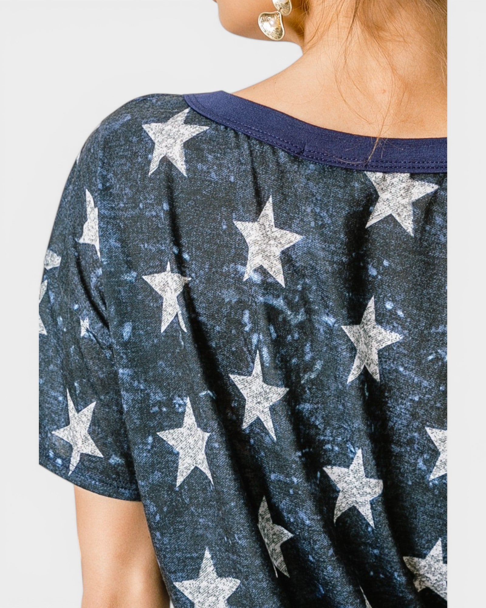 Navy blue top with silver star pattern on a plain background