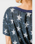 Navy blue top with silver star pattern on a plain background