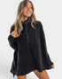 Woman wearing a dark gray poncho on a white background