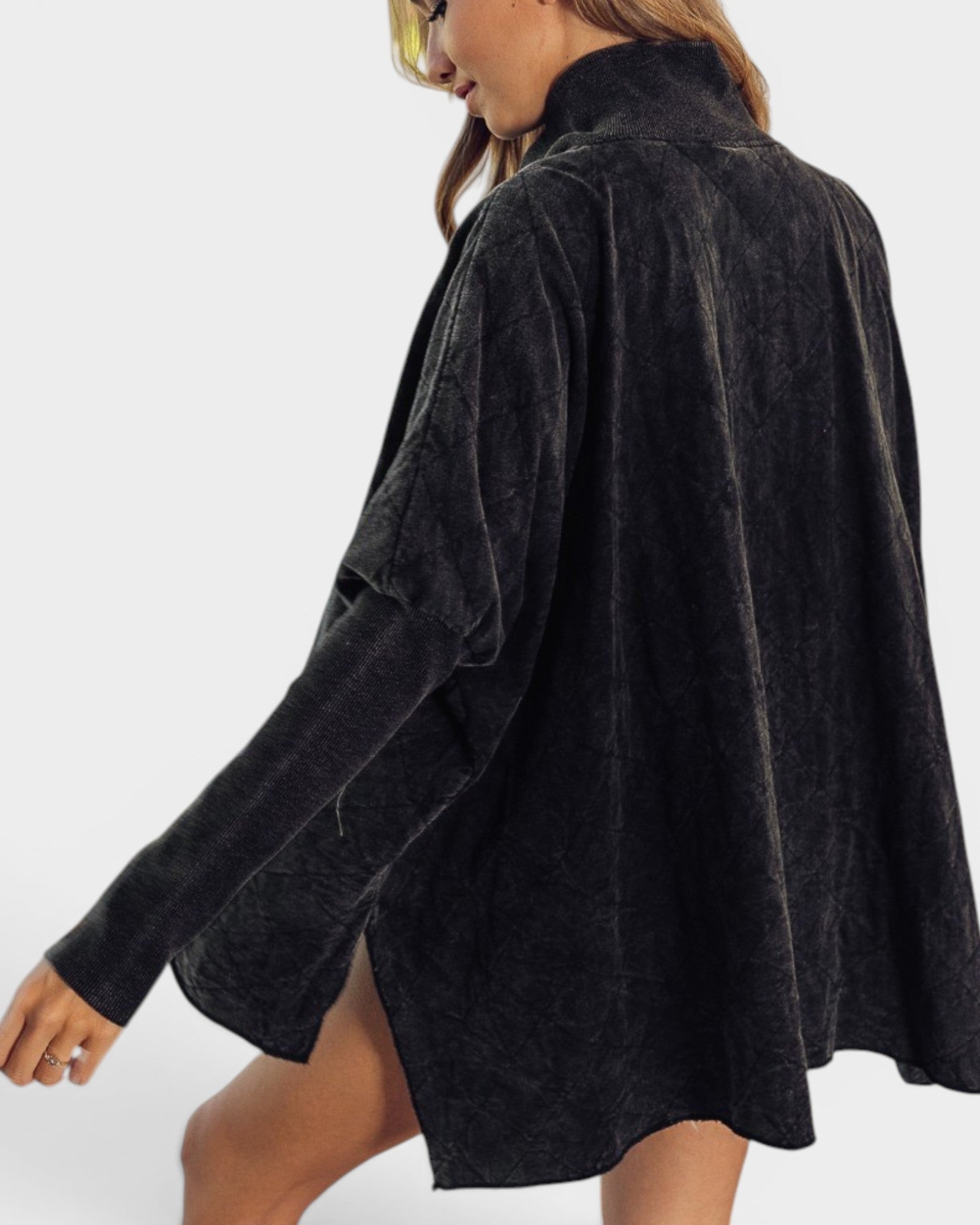 Black textured shirt worn by a person on a white background