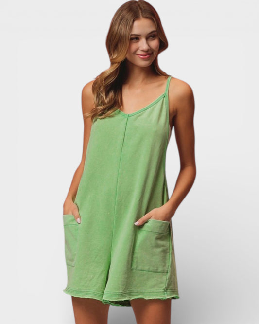 Woman wearing a green dress with pockets on a white background