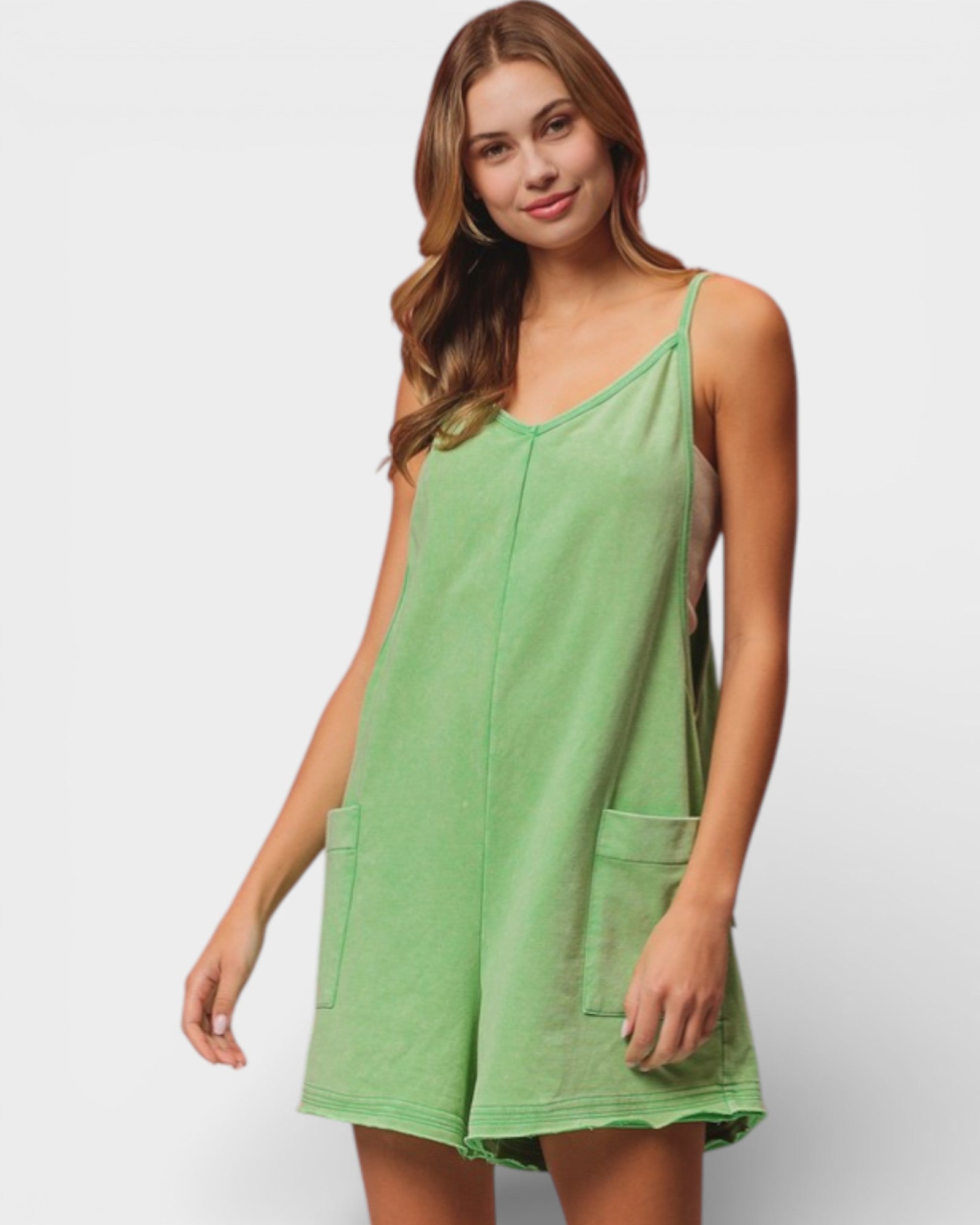Woman wearing a green sleeveless dress on a white background