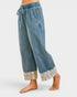 Blue denim pants with lace cuffs on a white background