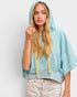 Woman wearing a light blue hoodie with a plain background