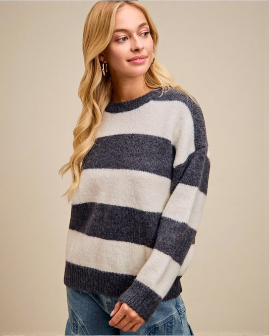 Woman wearing a striped sweater against a beige background