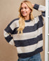 Woman wearing a striped sweater against a beige background