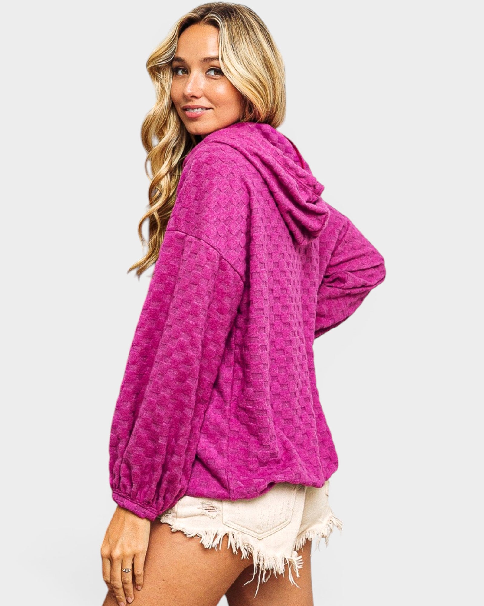 Woman wearing a pink hoodie on a white background