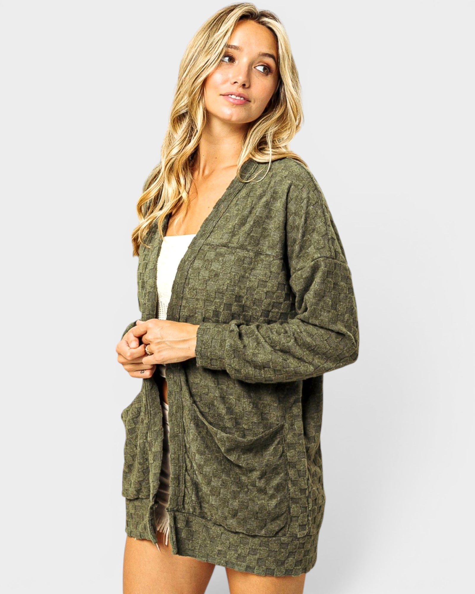 Woman wearing a green cardigan on a white background
