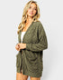 Woman wearing a green cardigan on a white background