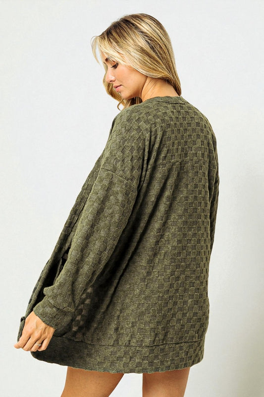 Woman wearing a green patterned dress against a white background