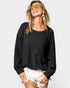 Woman wearing a black oversized sweatshirt with a pocket on a white background