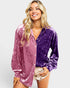 Woman wearing a two-tone purple velvet shirt on a white background