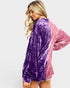 Woman wearing a purple and pink velvet dress on a white background
