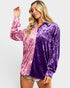 Woman wearing a pink and purple velvet shirt on a white background