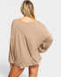 Beige oversized sweater worn by a person on a white background