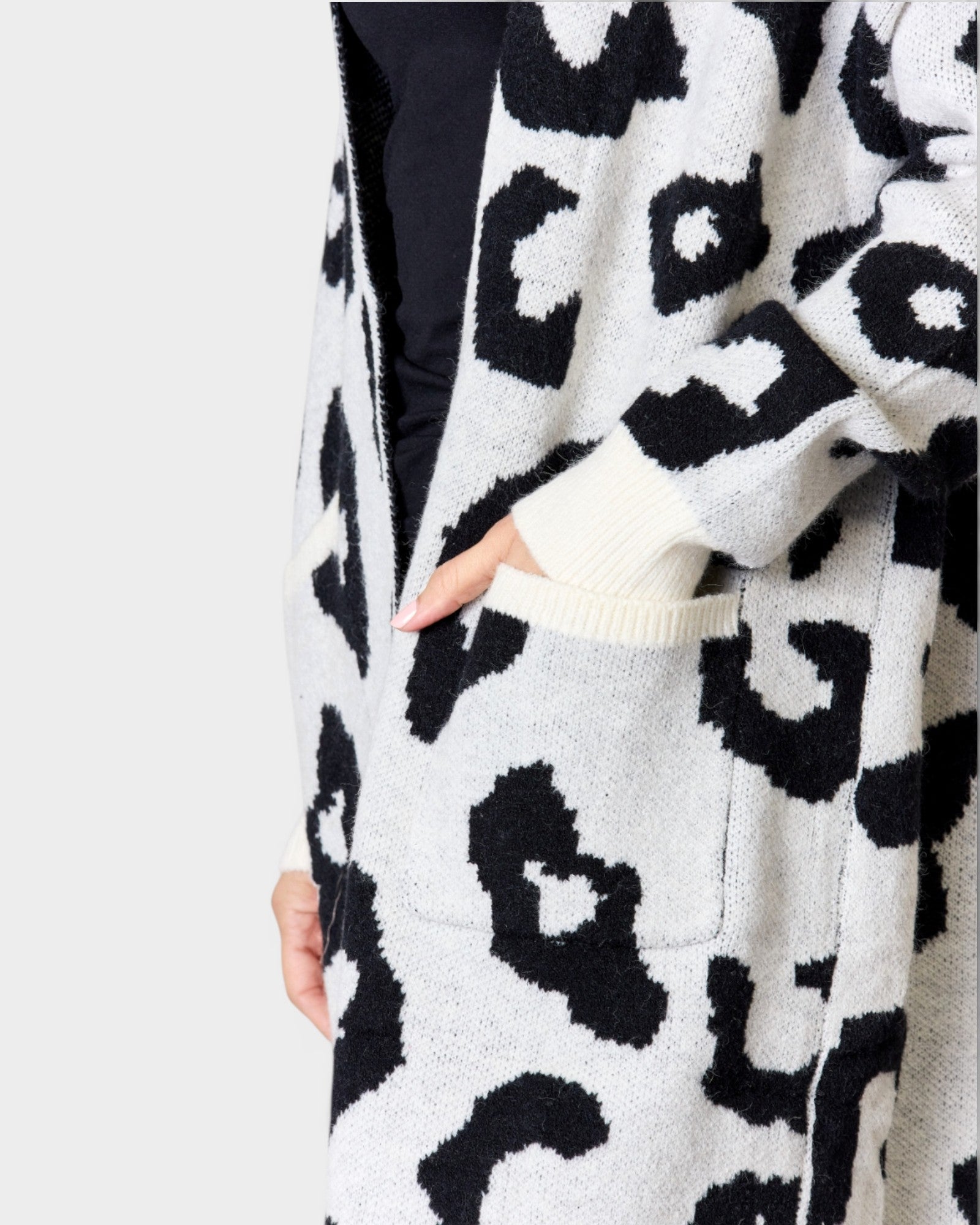 Leopard print cardigan worn by a person on a white background