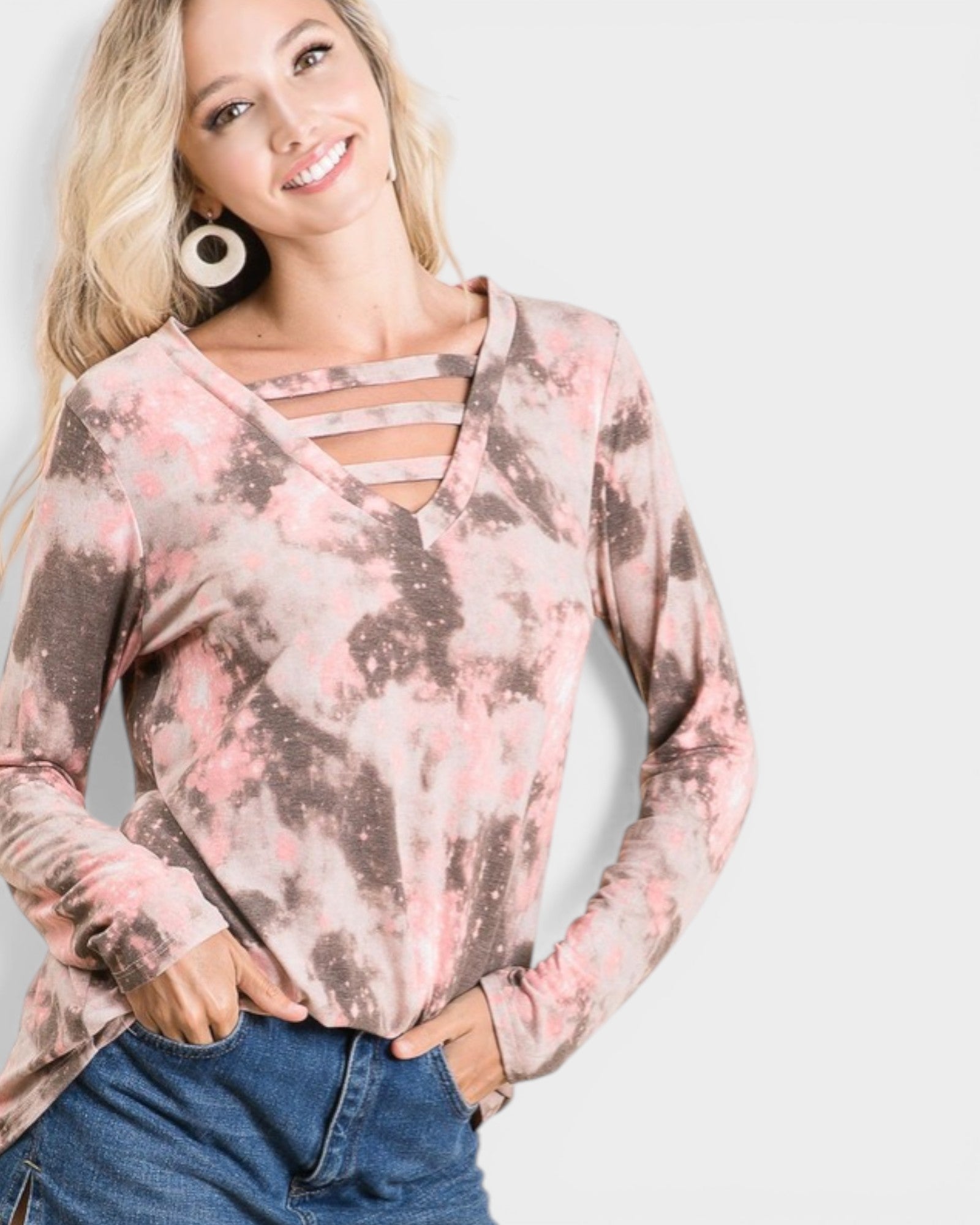 Woman wearing a long-sleeve top with a floral pattern on a plain background