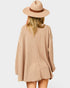 Person wearing a beige checkered dress and hat on a white background