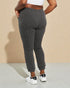 Person wearing gray ribbed sweatpants on a beige background