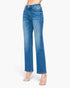 A model wearing a pair of medium wash blue straight-leg jeans with a slight fade on the thighs, paired with clear high-heeled sandals, shown against a plain white background.