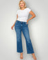 Woman wearing a white t-shirt and blue jeans on a plain background