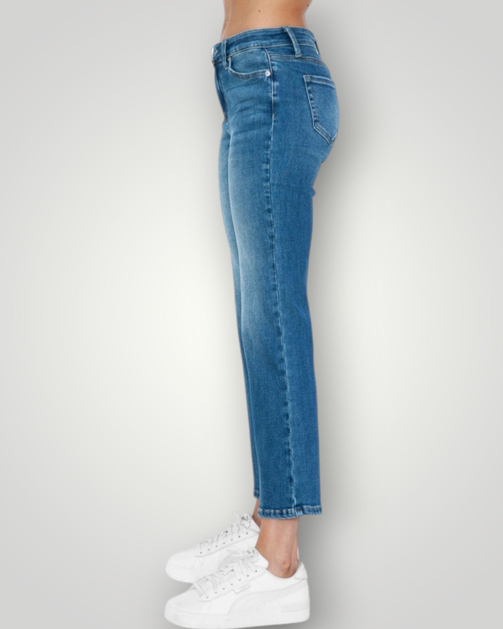 Blue jeans worn by a person on a white background