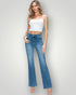 Woman wearing a white top and blue jeans on a plain background