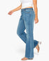 A model wearing a pair of high-waisted, wide-leg blue denim jeans with a faded wash, styled with a white crop top and clear-strap heeled sandals against a plain white background.