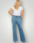 Person wearing blue jeans and a white t-shirt on a plain background