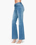A model wearing a pair of high-waisted, light blue flare jeans with clear high-heeled sandals, shown from a side profile against a plain white background.