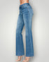 Blue jeans worn by a person on a plain background