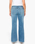 Rear view of a model wearing light blue wide-leg denim jeans with a white top, shown against a plain white studio background.
