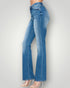 Blue jeans worn by a person on a light gray background