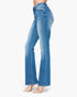 A side profile view of a model wearing high-waisted, light blue flare jeans and clear high-heeled sandals against a plain white background.