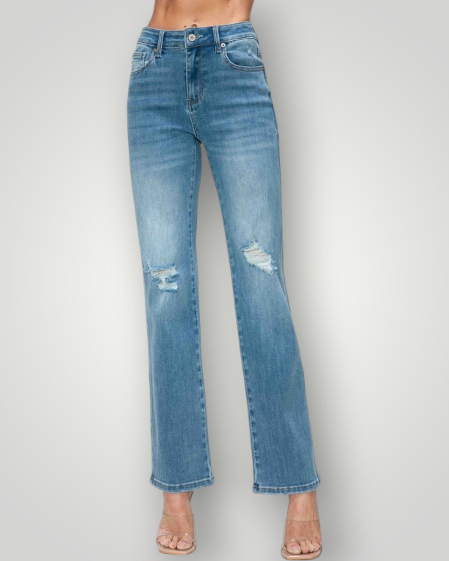 Blue jeans with slight distressing on a plain background