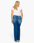 A woman viewed from the back wearing blue straight-leg jeans, a white short-sleeve t-shirt, and clear high heels against a plain white studio background.