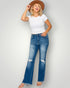 Woman wearing a white t-shirt and blue jeans with a brown hat on a plain background