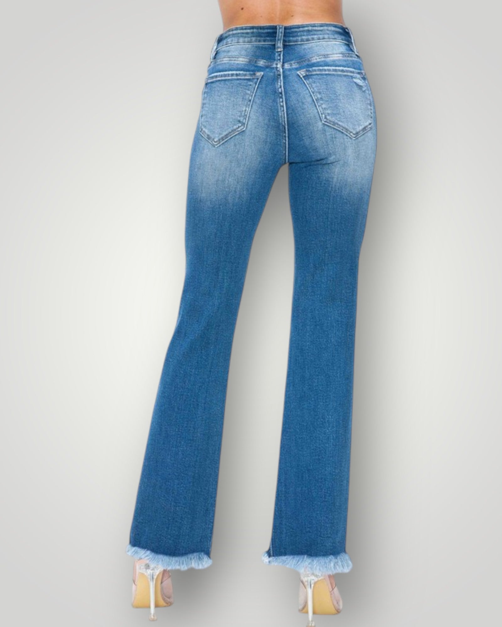 Blue flared jeans on a plain background