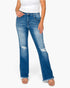 A model wearing a pair of medium-wash blue denim jeans with a distressed, slightly flared leg, paired with a white tank top and beige sandals, against a plain white background.