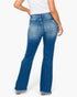 Rear view of a model wearing blue flare jeans with a frayed hem, paired with a white top, against a plain white background.