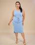 Woman wearing a light blue sleeveless dress against a beige background