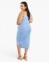 A woman modeling a light blue sleeveless midi dress with a wrap-style bodice and side slit, shown from the back against a plain white studio background.