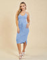 Woman wearing a light blue dress against a beige background