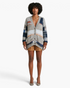 Beach Rose Co. relaxed patchwork knit cardigan with patterned stripes, V-neck, and patch pockets on a model