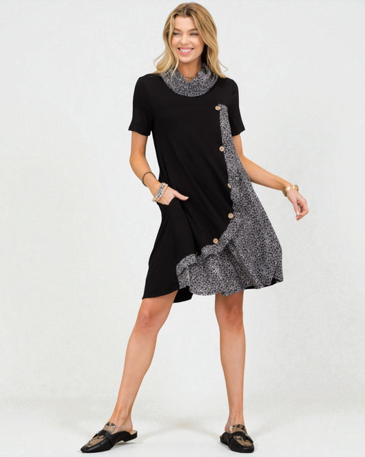 Woman wearing a black dress with a patterned overlay on a white background