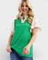 Woman wearing a green sleeveless top with a white collar against a plain background