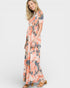Woman wearing a floral dress on a white background