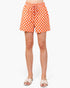 A person wearing orange and white checkered shorts with a drawstring waist, paired with light beige slide sandals, shown against a plain white studio background.