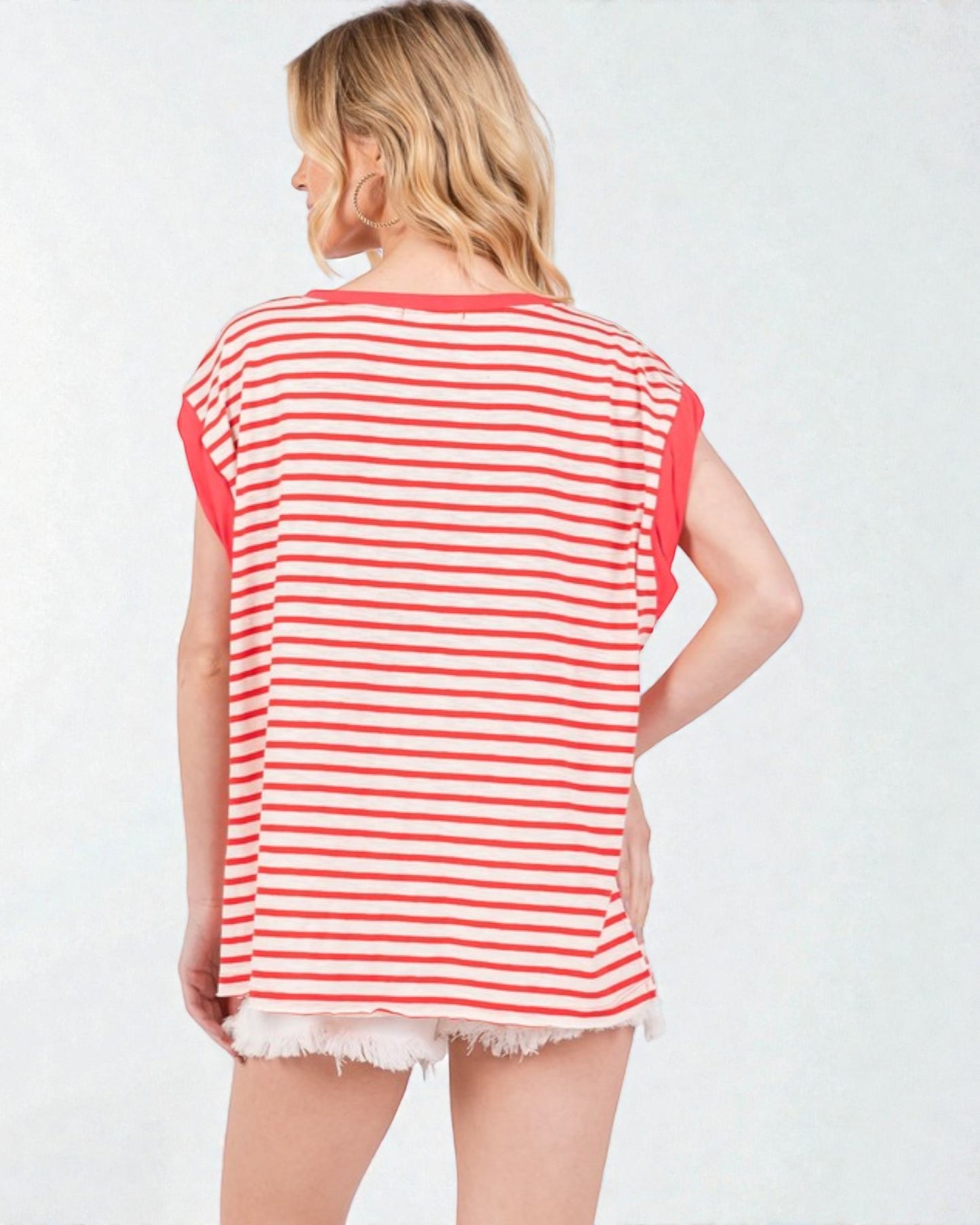Woman wearing a red and white striped sleeveless top on a white background